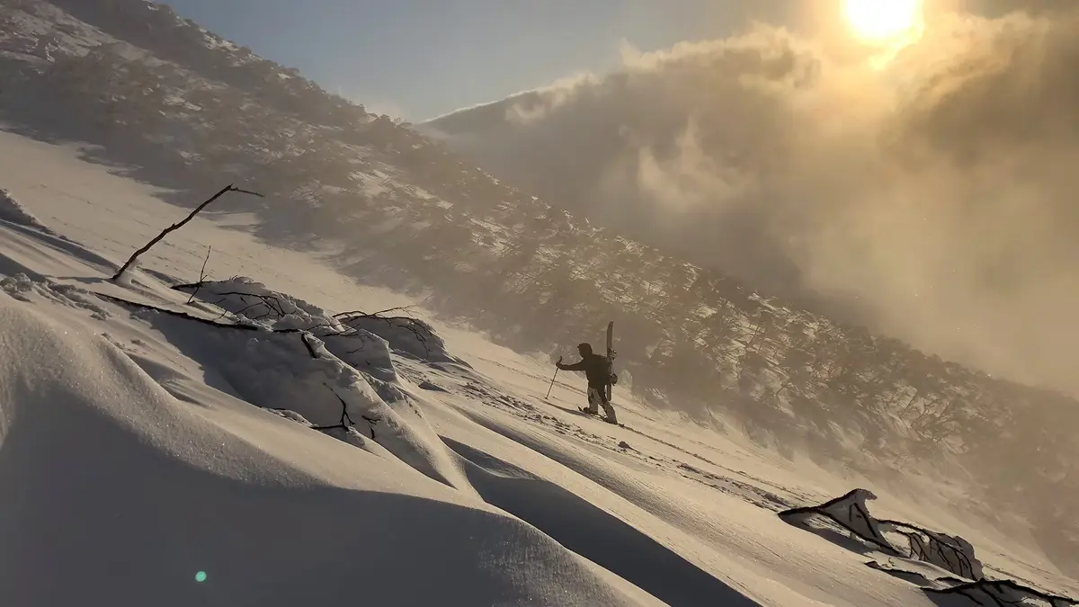 SAS Niseko guide leading a rider through backcountry powder